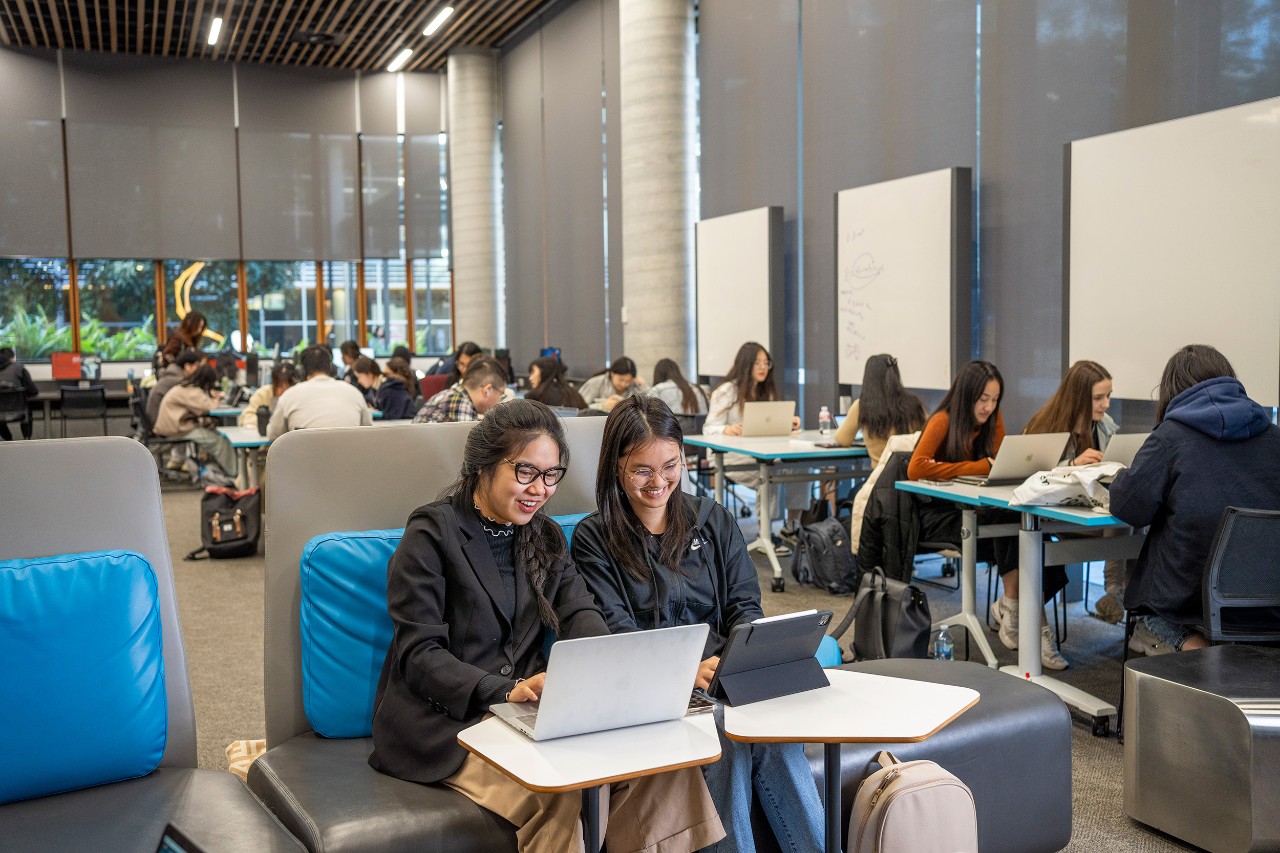 three students around a study desk at PNR Learning Hub