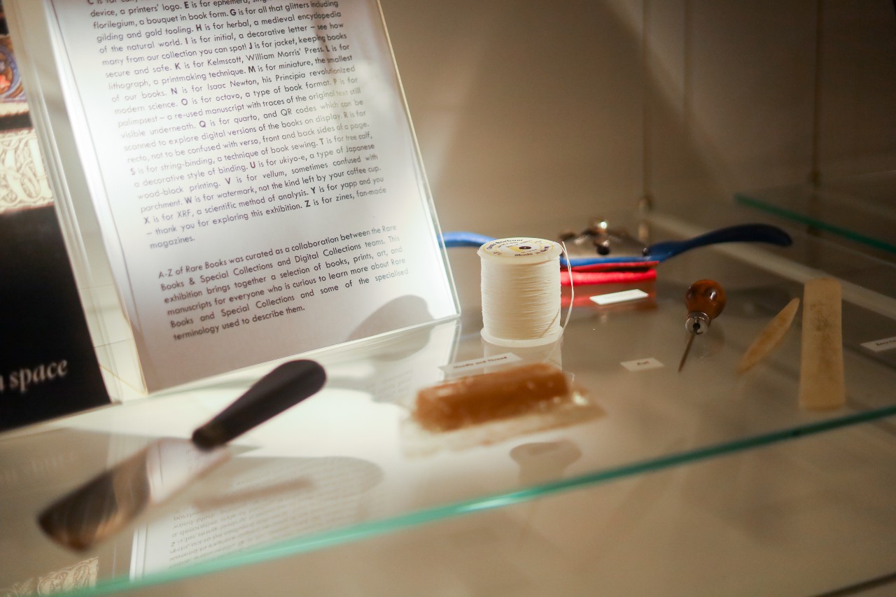 Book binding tools on display in a glass cabinet
