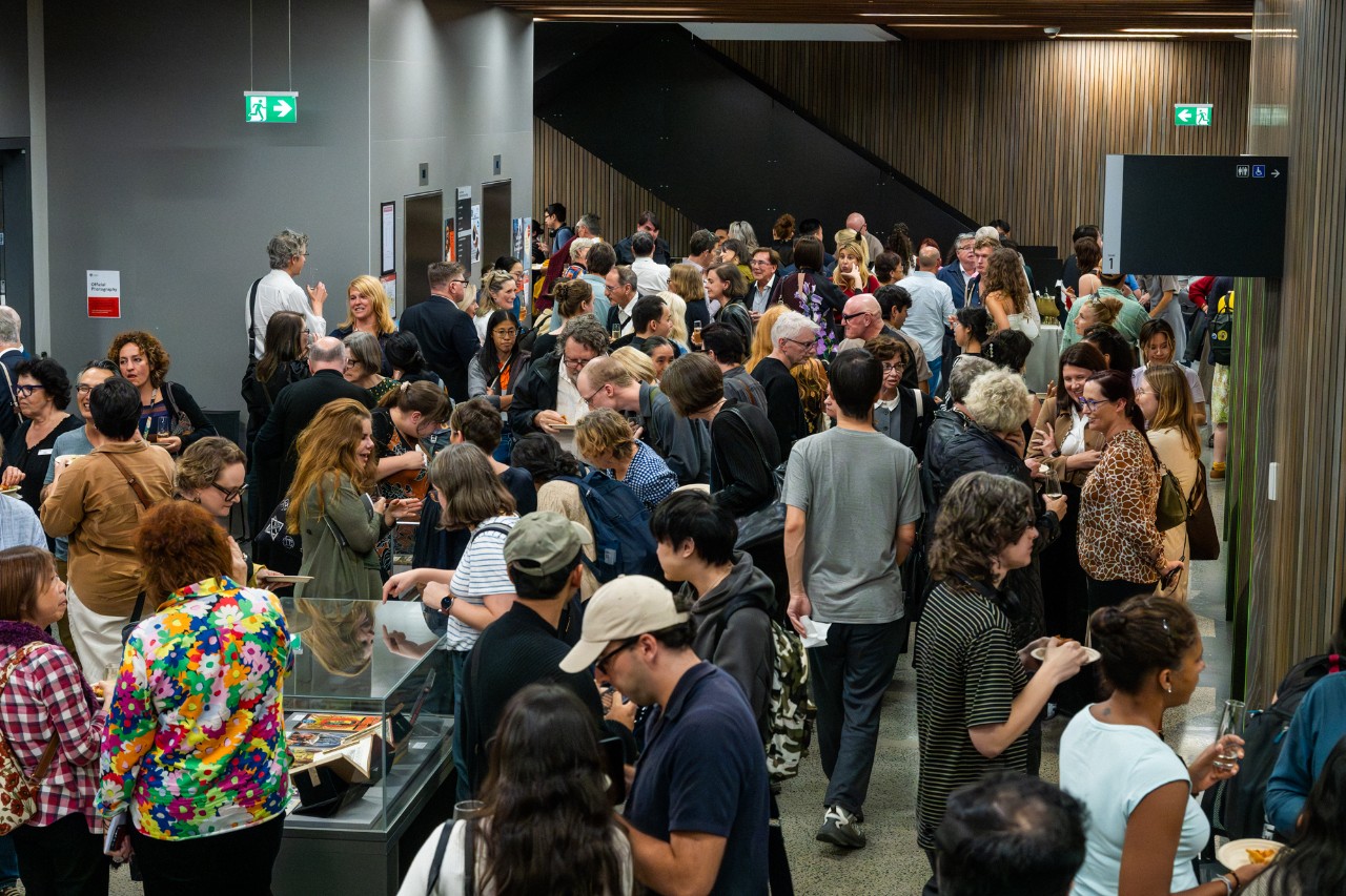 A large room filled with people mingling 
