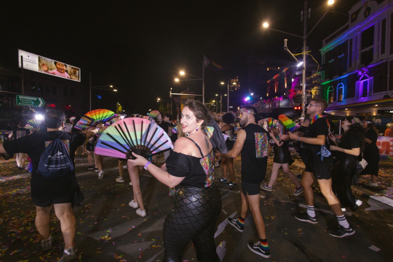 Mardi Gras marchers walking through Taylor Square