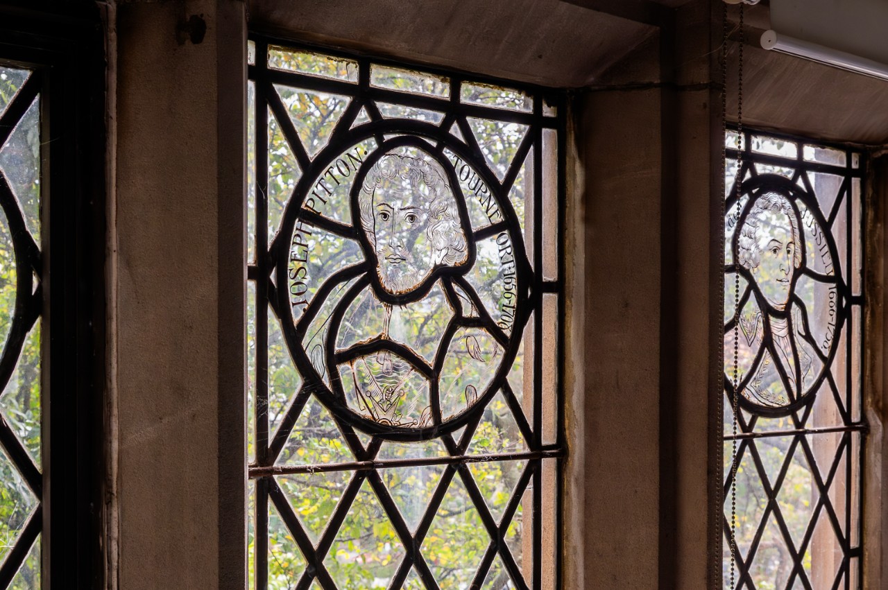 Close up of ornate windows featuring two portraits