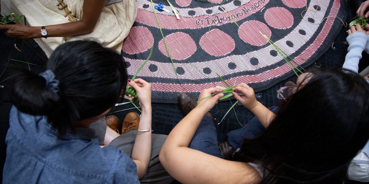Overhead shot of two people weaving