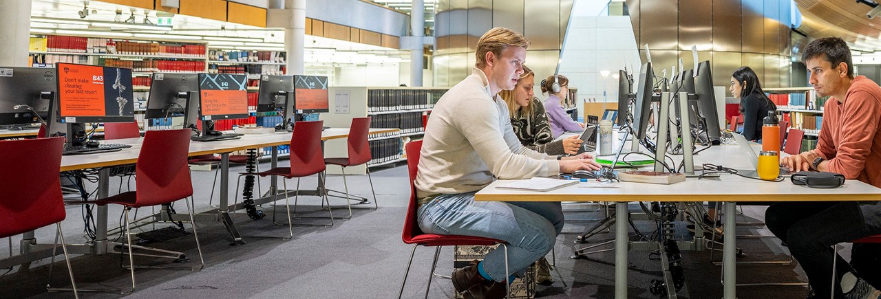 A group of students studying on computers at Law Library