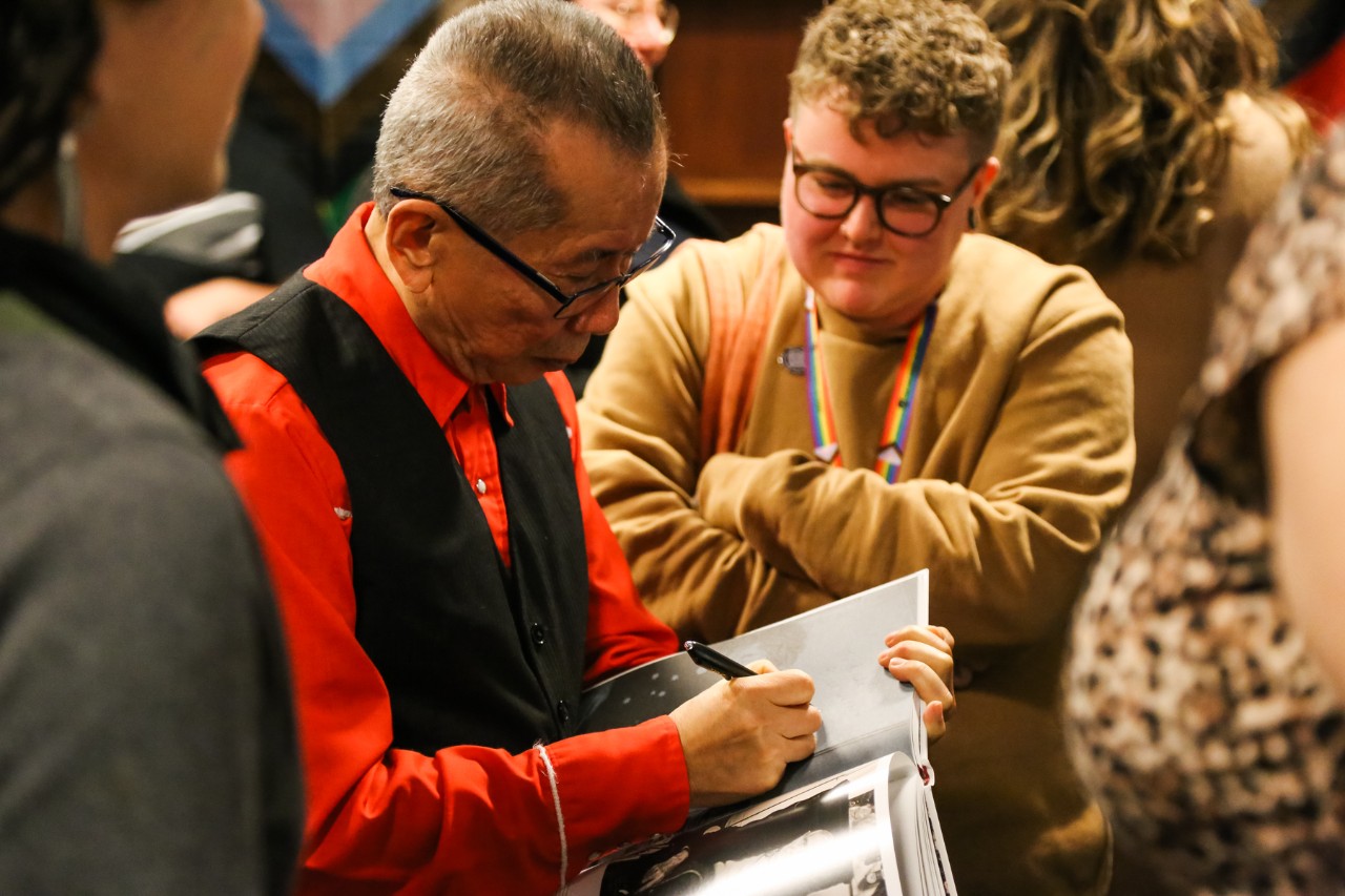 William Yan autographing a book