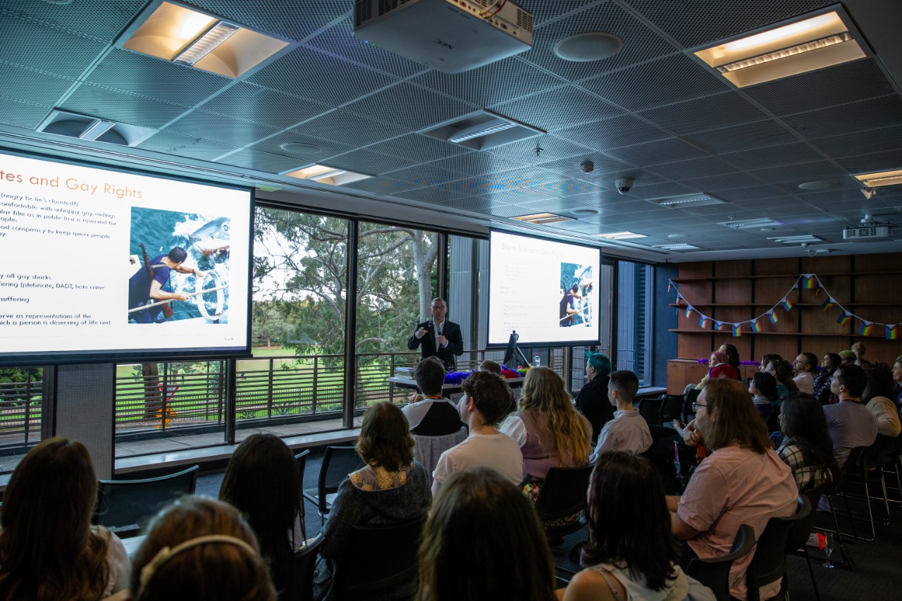 Chris Pepin-Neff presenting in front of an audience