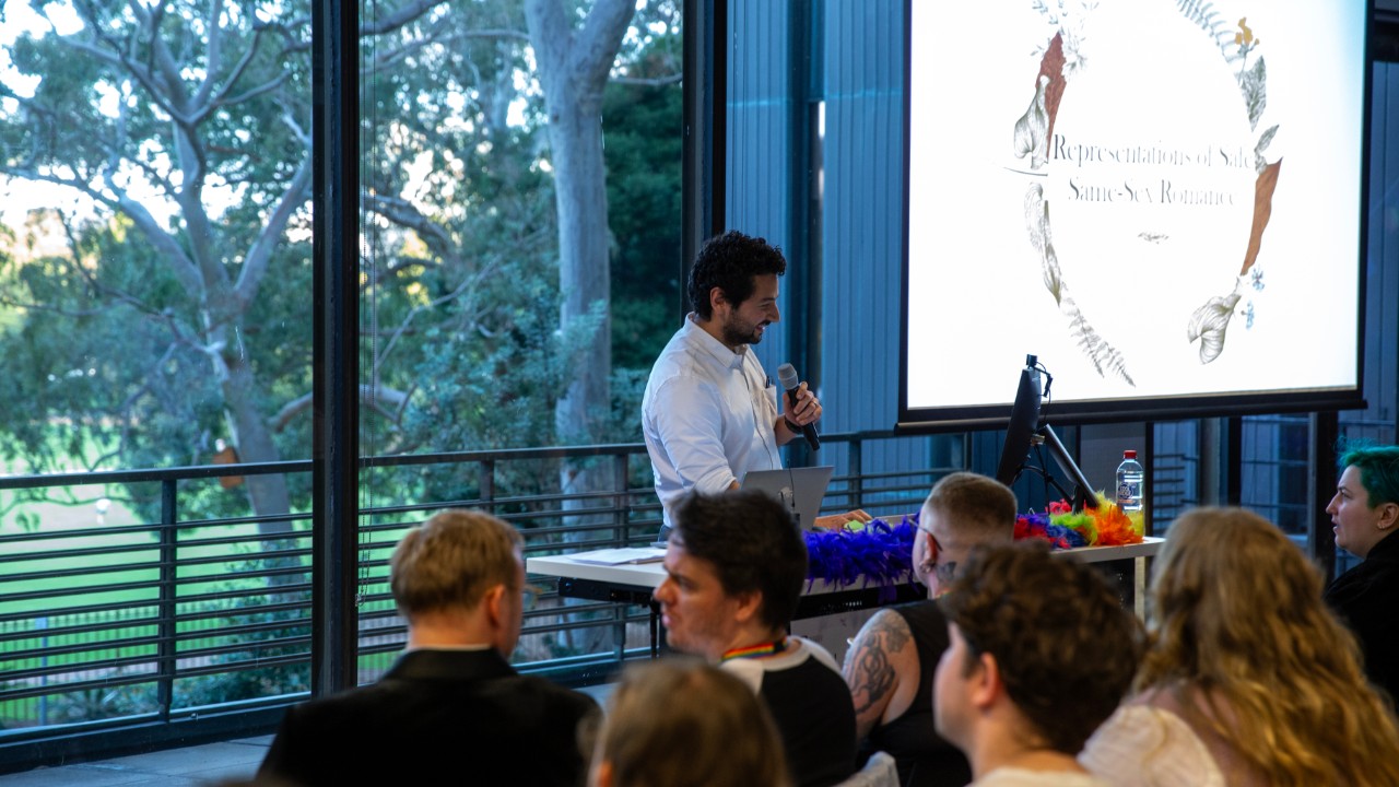 Levent Sahin presenting in front of an audience