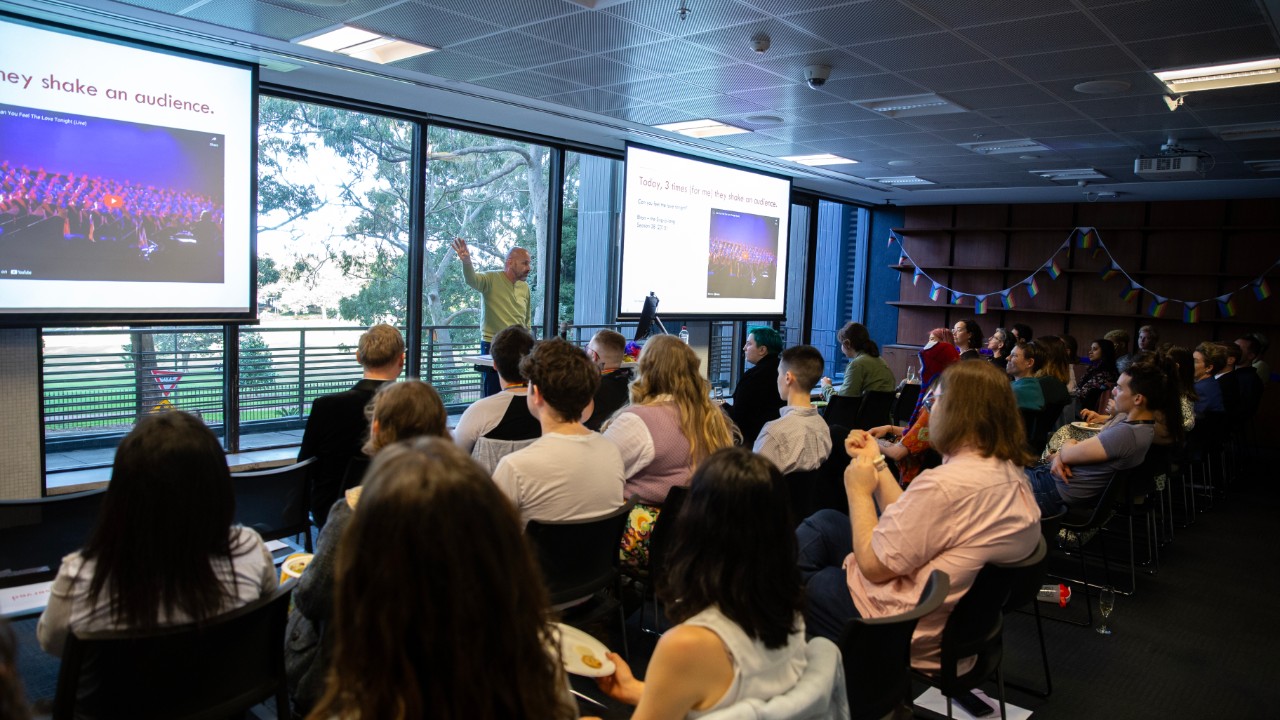 Dominic Hearne presenting in front of a crowd