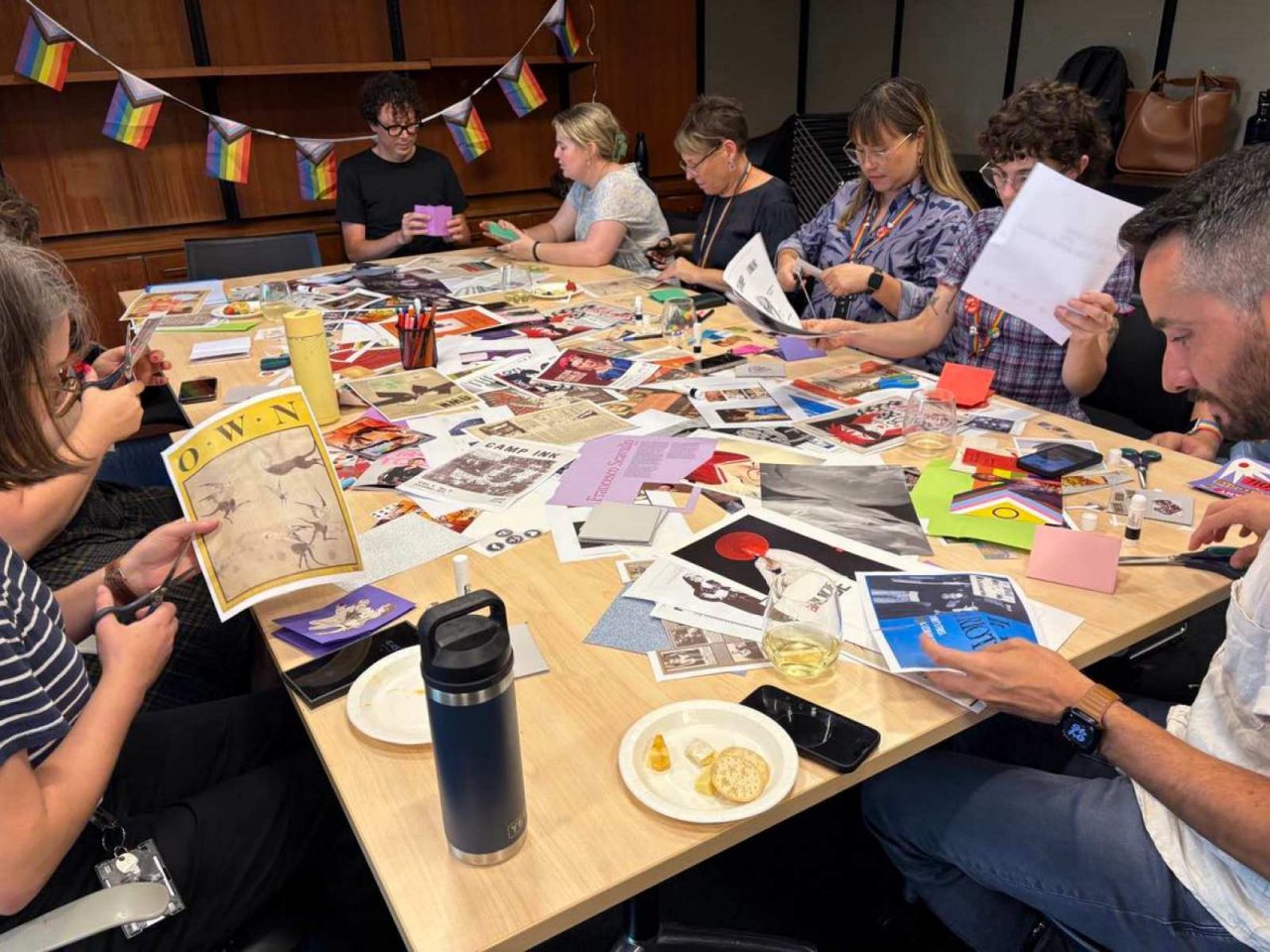 A colour photograph showing a group of people sitting around a table crafting together