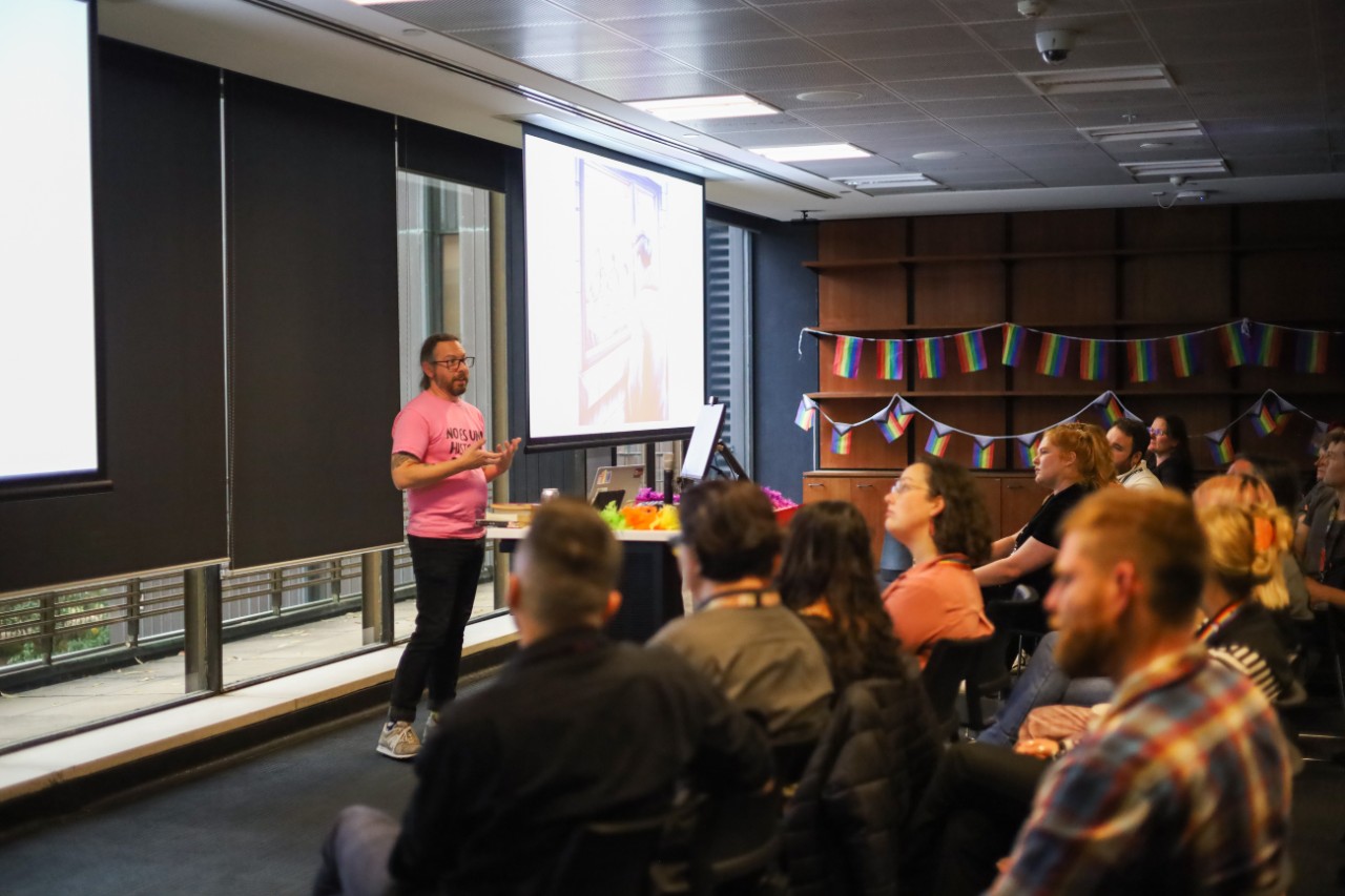 Daniel Smith presenting in front of an audience