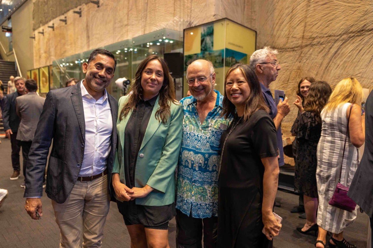 Group of four people smiling, in the Conservatorium