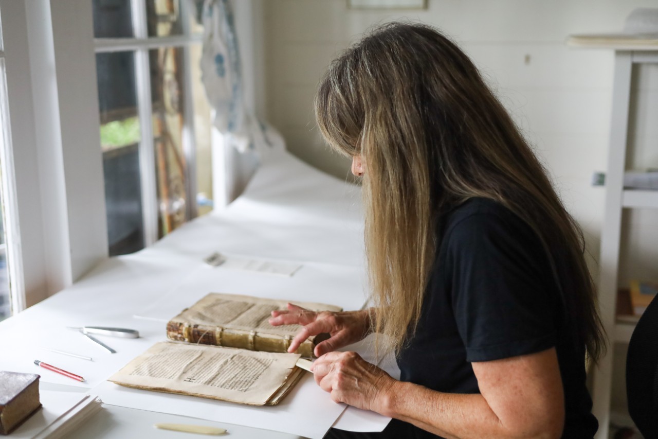 Conservator working on the book by Copernicus