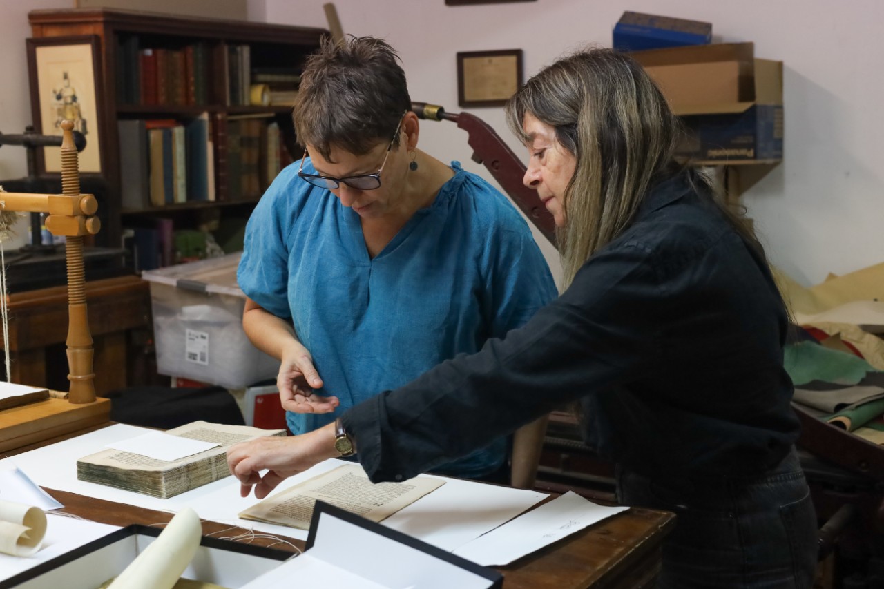 Julie and Gillian inspecting the book