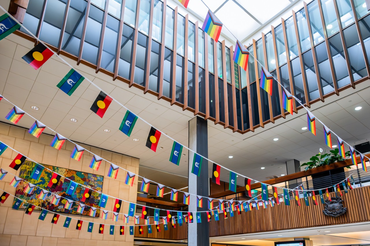 LGBTQIA+ and Aboriginal and Torres Strait Islander flags in the Fisher Library foyer